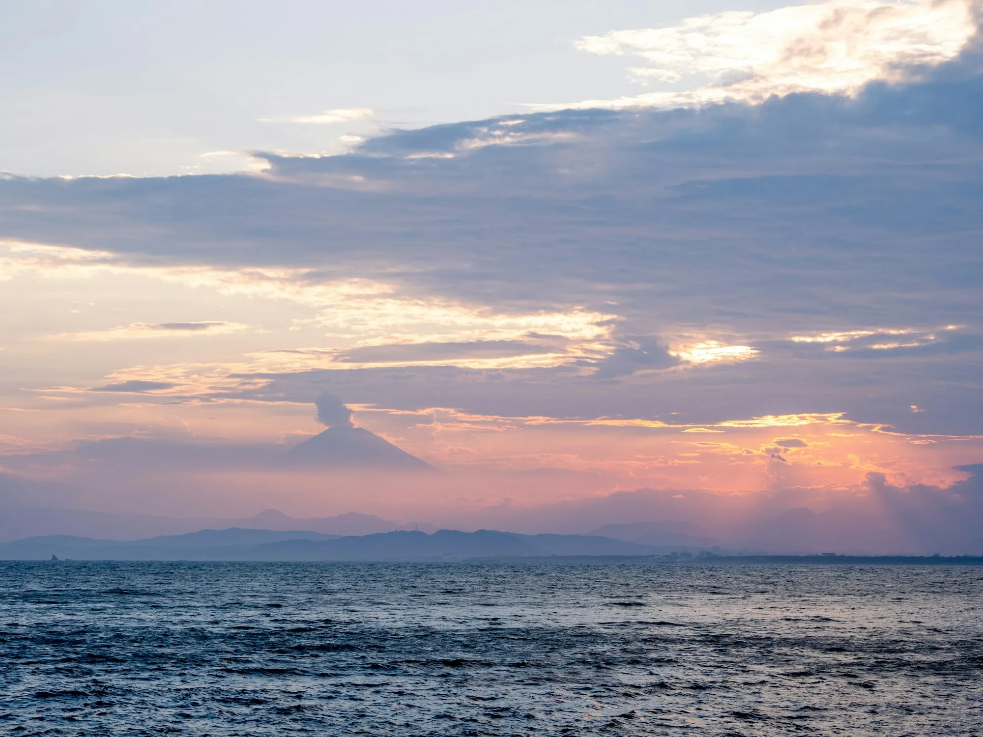 The sun setting over the ocean