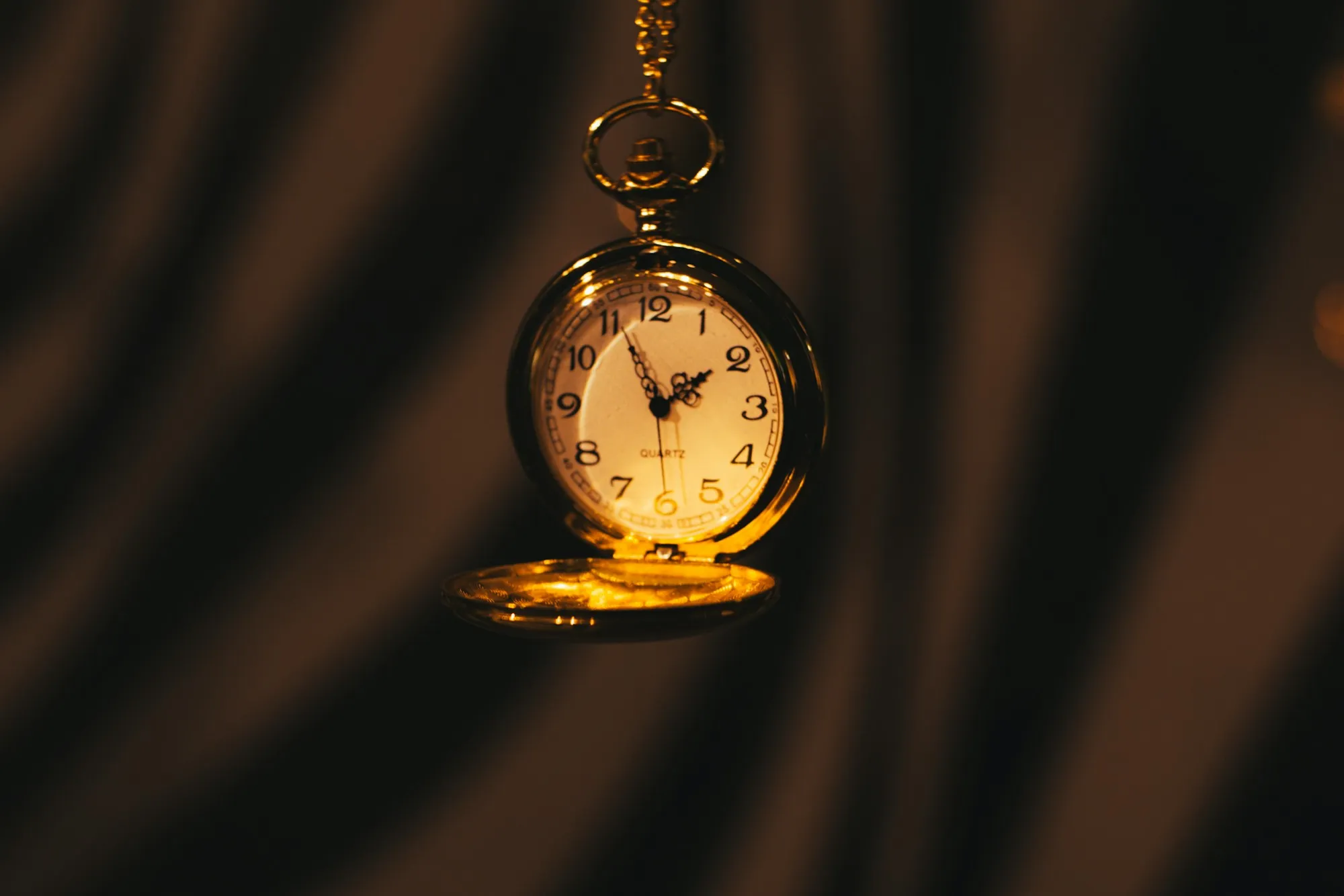 A gold pocket watch on a chain